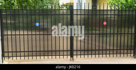 urban residential private property car access gate made from steel tubing and polycarbonate to protect viewer discretion Stock Photo