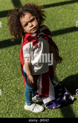 Small african american girl with american flag like superhero cape Stock Photo