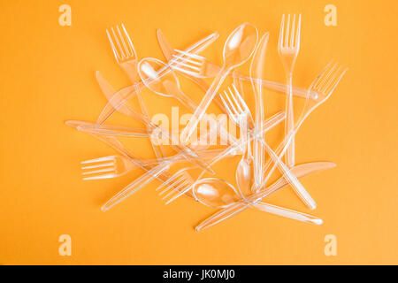 top view of set of various plastic cutlery isolated on orange Stock Photo