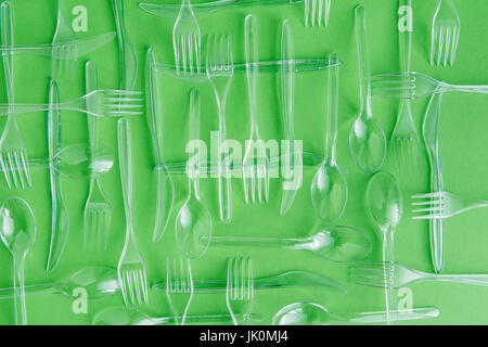 top view of set of various plastic cutlery isolated on green Stock Photo