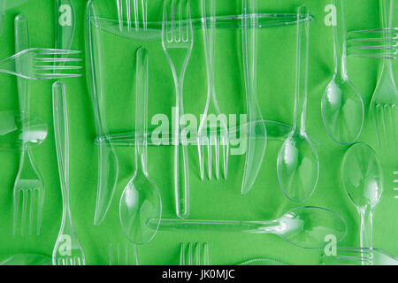 top view of set of various plastic cutlery isolated on green Stock Photo