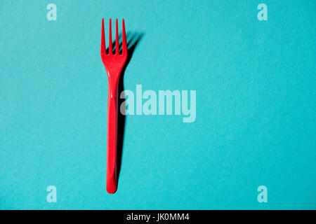 top view of red plastic fork isolated on blue Stock Photo