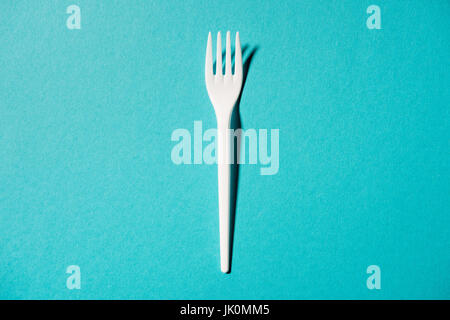 top view of white plastic fork isolated on blue Stock Photo