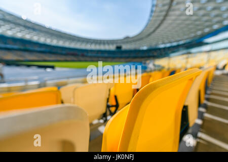 selective focus of yellow stadium seats on football stadium Stock Photo