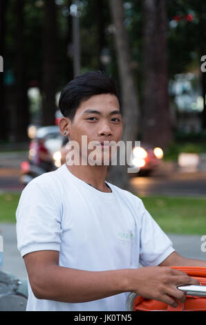 Portrait of a young man, a cyclo tour guide - Ho Chi Minh City - 15 March 2017 Stock Photo