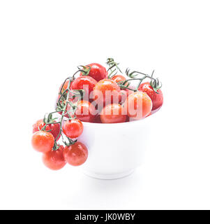 Fresh Cherry tomatoes in ceramic bowl on white background. Stock Photo