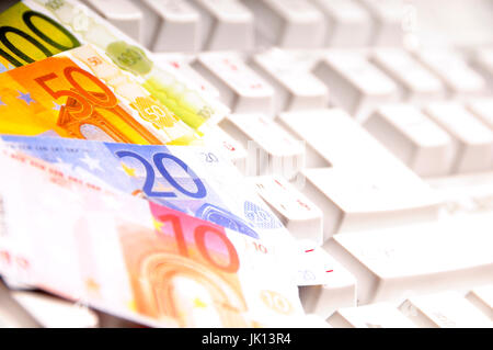 Euro banknotes on a computer keyboard Stock Photo
