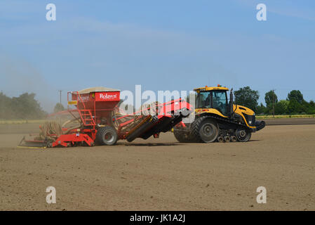 seeding machine working in field ellerton yorkshire united kingdom Stock Photo