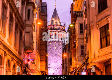 Night View of old narrow street with the Galata Tower(Turkish: Galata Kulesi)called Christ Tower by Genoese a famous medieval landmark in Istanbul. Stock Photo