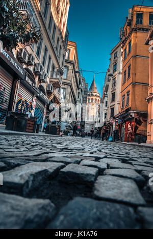 View of old narrow street with the Galata Tower(Turkish: Galata Kulesi)called Christ Tower by Genoese a famous medieval landmark in Istanbul Stock Photo