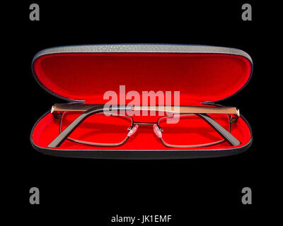 Gold Framed Spectacles in a red velvet lined hard shell case. All isolated on a black background. Stock Photo
