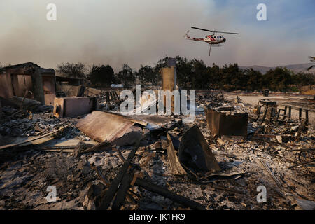 A helicopter replenishes water from farm house which has been distroyed by the Blue Cut Fire in Phelan, California, USA on 17th of August 2016. Pic ©  Stock Photo