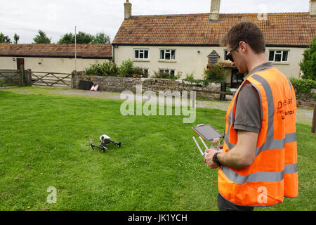 Licensed Drone Operator flying DJI Inspire 1 at a property in the UK Stock Photo