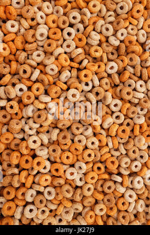 Healthy multigrain hoops breakfast cereal - wheat, barley, rice, oats and maize - as an abstract background texture Stock Photo