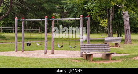 Children's swing set in public park Stock Photo