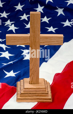 American wooden cross on USA flag. Stock Photo
