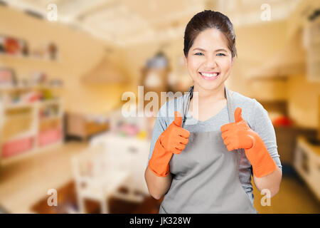asian housewife wearing rubber gloves thumbs up Stock Photo