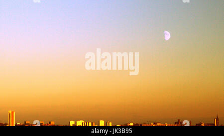 moon over Glasgow city wide view looking east colorful yellow sunset sky over the west  end cityscape skyline Stock Photo