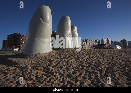 Uruguay, Punta del Este, Playa Brava beach, La Mano en la Arena, Hand in the Sand, sculpture. by Chilean Artist Mario Irarrazabal Stock Photo