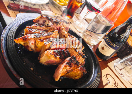 Cooked Bistecca alla fiorentina - Steak Florentine on a plate image taken in Florence, Tuscany, Italy Stock Photo