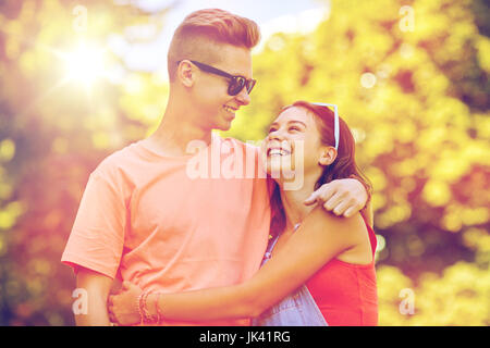 happy teenage couple looking at each other in park Stock Photo