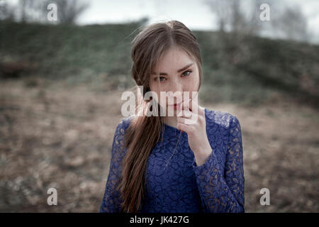 Wind blowing hair of curious Caucasian woman Stock Photo