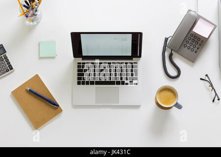 laptop, phone and other office stuff on table Stock Photo