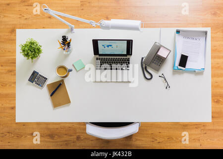 laptop, phone and other office stuff on table Stock Photo