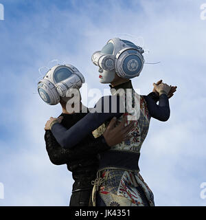 Couple dancing wearing face paint and virtual reality helmets Stock Photo