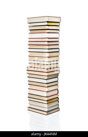 High stack of various books stacked one on another, isolated on white background Stock Photo