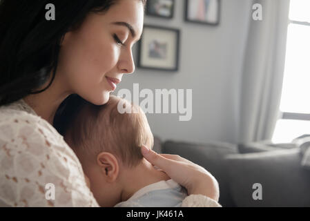 Caucasian mother comforting baby son Stock Photo