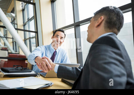 Businessmen shaking hands Stock Photo