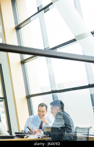 Businessmen smiling in meeting Stock Photo