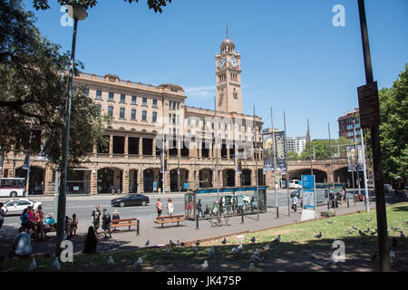 Sydney,NSW,Australia-November 18,2016: People waiting by bus stop and architecture of the Central Railway Station in downtown Sydney, Australia Stock Photo