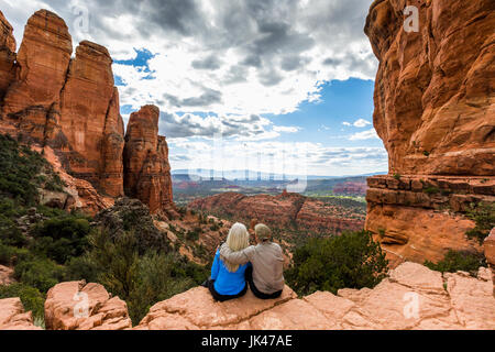 Caucasian couple admiring scenic view in desert landscape Stock Photo