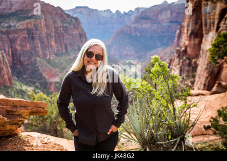 Caucasian woman posing near rock formations Stock Photo