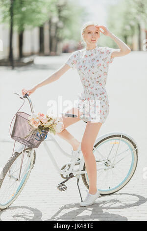 Middle Eastern woman sitting on bicycle Stock Photo