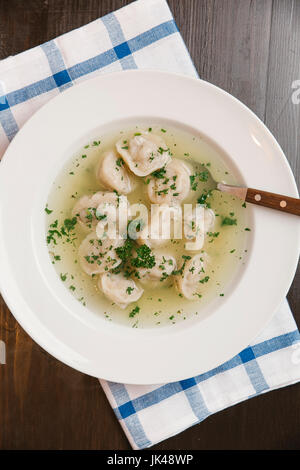 Dumplings in bowl of soup Stock Photo