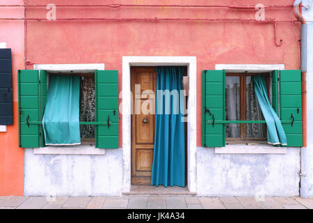 Colorful facade on retro house entrance with open door and windows Stock Photo