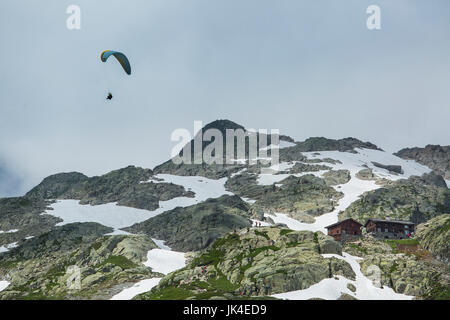 Parasailer flies over the ice and snow in the French Alps above Chamonix. Stock Photo