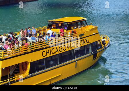 A water taxi preparing to stop to allow passengers to disembark and board at the Chicago River riverwalk in downtown Chicago, Illinois, USA. Stock Photo