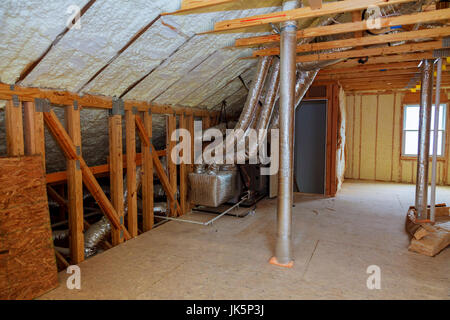 Foam plastic insulation installed in the sloping ceiling of a new frame house. Stock Photo