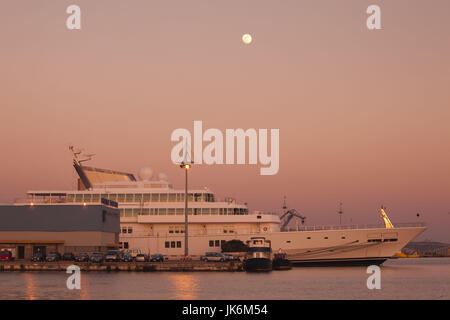 Italy, Sardinia, Cagliari, yacht by the Stazione Maritima, dusk Stock Photo
