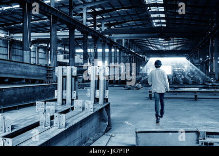 Steel processing plants and technicians with helmets Stock Photo