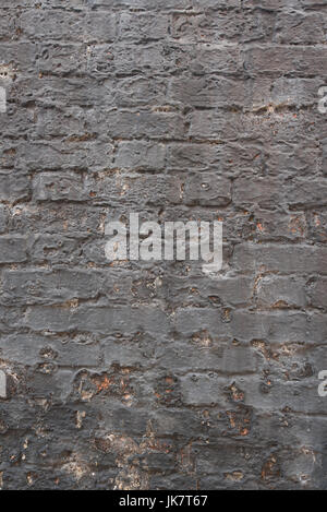 Old brick wall with cracked and peeling plaster Stock Photo
