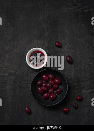 Carissa carandas Bengal-Currants, Carandas-plum,Kuranda with jam Healthy fruit on wooden black background Stock Photo