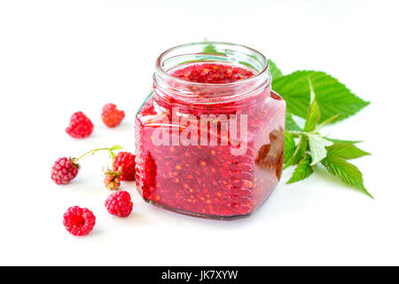 Homemade homemade jam. Glass jar with raspberry jam on a white background. Preserved berry. Stock Photo