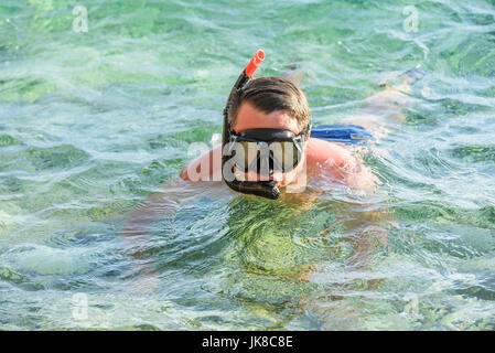 Man in a diving mask in sea water. Stock Photo