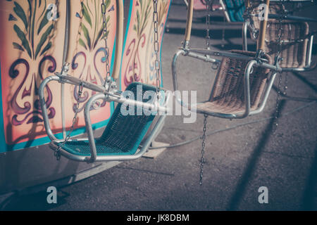 Empty seats on a merry-go-round Stock Photo