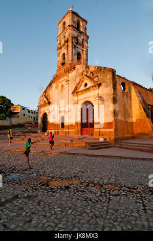 Children playing in front of ruins of Church Iglesia de Santa Anna in Trinidad Cuba; Stock Photo